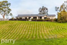 32 Vrouka Place HADSPEN  TAS 32 Vrouka Place is located in the small township of Hadspen only 9 minutes commute to Launceston's CBD. At the end of a quiet cul-de-sac you will enter a long internal drive and arrive at this grand residence. The house is perched on the side of the hill accessing full views of the South Esk River. The home sits on 7683 square meters of land with side access down to the river where there are numerous walking tracks. This large family home is approximately 36 square meters and is constructed with a brick render finish, inside there are 4 good-sized bedrooms all with built in wardrobes. The master bedroom features a huge walk in robe and a luxury corner spa in the en-suite. There is plenty of room at both the front and rear of the property, if you're using the rear of the property it could be great for a large family pet such as a horse or some sheep. There is already a double garage with internal access, however if you are looking to expand this storage space, the front of the property has great potential for further garages or sheds. With its timeless elegance, this home flows seamlessly through multiple living areas, great for separating the kids while the parents entertain. The kitchen is situated at the hub of the home with granite bench tops and surrounded by polished timber floorboards that flow through to the dining and lounge areas. 