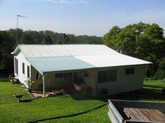  168 Hillcrest Road, Yandina, Qld 4561   Hidden away in the foothills of the Blackall Ranges this 11.83 ha (29 acres) of undulating rainforest property offers a 3 bedroom spacious dwelling with new iron roof, a 28m X 9m 5 bay Besser block shed with a 2 bedroom unit attached. There are other sheds and water is plentiful with 2 x 6000, 1 x 5000 and 1 x 3000 gallon poly tanks as well as 2 dams. There is ample opportunity for farm stay or B & B ( subject to council Regulations). There are 60 mature fruit trees of different varieties including orange, mandarin, grapefruit, peach, apple, avocardo & mango whilst the rear of the property is 4 wheel drive country with expansive rainforest, creeks and waterfalls. 