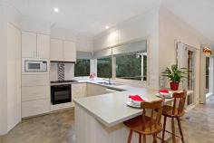  32 Wandarra Way Warranwood VIC 3134 4333Price Guide: More than $670,000   |  Land: 652 sqm approx 	   |  Type: House  |  ID #111891 Barry Plant Ringwood T 03 9870 5555 EMAIL OFFICE Nicole Freene T 03 9870 5555  |  M 0448 877 387 EMAIL AGENT Aaron Chuah T 03 9870 5555  |  M 0408 828 000 EMAIL AGENT Details Map/Directions Area profile   Carefully Designed To Offer The Ultimate Family Lifestyle From its quiet cul de sac location to the carefully planned two-storey floorplan, much thought has gone into creating this gem of a home that truly offers the ultimate family lifestyle. Careful consideration has gone into every aspect of this home to ensure its durability for everyday family living and ability to entertain on a very grand scale. It's therefore no surprise to note that large families are comfortably catered for within this space-laden home, which boasts three separate living areas along with a magnificent entertaining terrace that's virtually another room in itself! The home's grand persona is portrayed in the flowing sense of space shared by each of its radiant living areas, which maximise space and suited for a host of living requirements. Evoking the charm of a country lifestyle with its leafy surrounds and tranquil ambience, leadlight windows adorning the top of large, frameless windows are definitely in keeping with the home's period-inspired theme. Grand open-plan living with a large, well-appointed kitchen and family living with wood combustion fireplace makes for a superb centrepiece and combines with the spectacular wrap around deck that floats amongst the treetops, delivering the perfect indoor-outdoor entertaining set-up or peaceful sanctuary for that afternoon escape. While on the topic of peaceful sanctuaries, the light-filled formal lounge (with adjacent dining) frames pleasant front garden views as you unwind with a book in hand; teenagers, meanwhile, have a downstairs retreat to call their own. And with its own entrance, access to a large bedroom (with built-in robes) and brand new bathroom facilities on hand, it's also dressed with the flexibility of multi-generational living. Bedrooms of generous proportions delight with their comfort and space, while a huge amount of storage in and around the home promotes clutter-free living. Finished with gas ducted heating plus split-system heating and cooling and boasting a family-friendly location within excellent access of well-regarded private schools, scenic parkland, Eastland Shopping Centre and Eastlink 