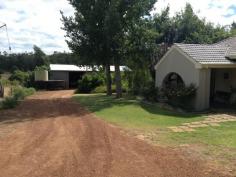  53 Hackett Road Donnybrook WA 6239 5 acres, 2 homes, large shed, income. Located 3kms to the south east of Donnybrook and within the town boundary, this 5 acre rural zoned property includes 2 homes, an 18m x 12m shed with 3 phase power, garden shed/storeroom, tanks & equipped bore, and income producing plantings of orchard and protea's. The well presented rendered brick and tiled roof main home features 4 good sized bedrooms, lounge, kitchen (timber feature cupboards), dining with reverse cycle air conditioner, entry hall, main bathroom, shower and toilet off the laundry, polished jarrah floorboards throughout much of the home and solar hot water system. The home, with attached patio and front porch, is set in established gardens that provide it with some privacy from an insulated 4-5 year old second home. This insulated home, built of timber stud framing, rendered compressed cement wall cladding, iron roof sheeting and concrete floors, features 3 good size bedrooms. Each bedroom has tiled floors, built in robes, vertical blinds, with an ensuite to the main bedroom, while open plan kitchen, dining and lounge have vinyl floor covering, vertical blinds and reverse cycle air conditioning. The main bathroom includes a toilet. General Features Property Type: Lifestyle Bedrooms: 7 Bathrooms: 3 Land Size: 2.02ha (5.00 acres) (approx) Outdoor Features Carport Spaces: 1 Garage Spaces: 3 