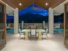  1 Wirrega Close Caravonica QLD 4878 The Judges Choice for 2010 Master Builders Association Awards 2010  Best Bathroom  Best Design For The Climate Housing Industry Association Awards 2010  House Of The Year  Best Custom Build Home Of The Year Located in Cairns most prestigious estate, only a 10 minute drive from the international airport and 15 minutes from Cairns City Centre, this 5 star resort style home is designed for the tropics with cross flow ventilation and air conditioned throughout. The huge designer kitchen has top quality appliances and stone bench tops, with self closing drawers, overlooking the sunken leather lounge and wet bar. The fabulous pool and spa is complimented by a fully tiled alfresco dining and tropical garden area, surrounded by magical mountain views. The master bedroom with spa access, views and enormous ensuite, a formal dining room, powder room and office with separate entrance for the professional complete this pavilion. Three generous bedrooms with built-in robes, unique bathroom, fully equipped laundry and walk-in linen storage area finish the second pavilion. The third pavilion consists of a four car garage, with 3.5 metre access for all the boys toys. The gatehouse entry continues into the fully covered timber breezeways connect the pavilions which are complimented with tropical plants and automated lighting. 