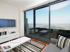  6003/7 Riverside Quay Southbank VIC 3006 Maximising wraparound Albert Park, MCG, Botanical Garden views to bay view, this resort style skyhome reveals a scenic retreat graced with a cleverly integrated in/outdoor design to bask in the vibrancy of Melbourne from each and every window.  The defined living and dining areas capture picture views and soak up an abundance of natural light. An open granite kitchen is equipped with Miele appliances and seamless cabinetry.  Residents enjoy access to a premier selection of facilities including a gymnasium, pool, sauna, private cinema, 24 hour concierge and video intercom and lift access.  The double-sized bedroom includes wide built-in wardrobes and direct access to a stylish ensuite. Additional features include a separated laundry, guest powder room, ducted air conditioning, chic downlights and single carport. It represents a remarkable investment opportunity for those seeking an unparalleled lifestyle location with popular demand and a high rental yield.  It is proudly set on the 60th floor and enviably located within easy walking distance to sports venues, Crown Casino, Arts precinct, Southbank shops, cafs, restaurants and transport options. 	 