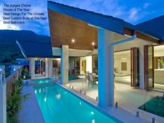  1 Wirrega Close Caravonica QLD 4878 The Judges Choice for 2010 Master Builders Association Awards 2010  Best Bathroom  Best Design For The Climate Housing Industry Association Awards 2010  House Of The Year  Best Custom Build Home Of The Year Located in Cairns most prestigious estate, only a 10 minute drive from the international airport and 15 minutes from Cairns City Centre, this 5 star resort style home is designed for the tropics with cross flow ventilation and air conditioned throughout. The huge designer kitchen has top quality appliances and stone bench tops, with self closing drawers, overlooking the sunken leather lounge and wet bar. The fabulous pool and spa is complimented by a fully tiled alfresco dining and tropical garden area, surrounded by magical mountain views. The master bedroom with spa access, views and enormous ensuite, a formal dining room, powder room and office with separate entrance for the professional complete this pavilion. Three generous bedrooms with built-in robes, unique bathroom, fully equipped laundry and walk-in linen storage area finish the second pavilion. The third pavilion consists of a four car garage, with 3.5 metre access for all the boys toys. The gatehouse entry continues into the fully covered timber breezeways connect the pavilions which are complimented with tropical plants and automated lighting. 