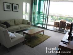 11403 8 Harbour Rd
HAMILTON Qld 4007 This modern one bedroom apartment is perfectly situated in the heart of the prestigious Hamilton vicinity boasting resort style living including an infinity pool and barbecue area set amongst lush tropical gardens. This one bedroom apartment has a real sense of space with its floor to ceiling glazing showcasing the suburban views of Ascot and Hamilton. At the centre of the open plan design, lies the linear style kitchen. Its contemporary design is ideally matched with quality appliances. The alfresco balcony is perfect for entertaining. The innovative bi-fold windows ensures that this area can be used in all weather types and provides a separate dining area. The queen sized bedroom features mirrored built in wardrobes with blockout blinds. In the bathroom you'll find a stone topped vanity and quality fixtures. The apartment is also wired with fibre optic cabling to keep your apartment abreast of advances in communication and entertainment technology, well into the future. Offering an abundance of accessible shops within the precinct including Woolworths, Domino's Pizza, Coffee Club, Shinzhen Sushi to name a few and a 3 minute walk to Portside Wharf and Racecourse Road Village, the location is perfect. 
