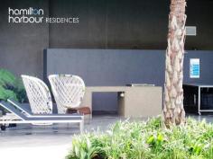 11403 8 Harbour Rd HAMILTON Qld 4007 This modern one bedroom apartment is perfectly situated in the heart of the prestigious Hamilton vicinity boasting resort style living including an infinity pool and barbecue area set amongst lush tropical gardens. This one bedroom apartment has a real sense of space with its floor to ceiling glazing showcasing the suburban views of Ascot and Hamilton. At the centre of the open plan design, lies the linear style kitchen. Its contemporary design is ideally matched with quality appliances. The alfresco balcony is perfect for entertaining. The innovative bi-fold windows ensures that this area can be used in all weather types and provides a separate dining area. The queen sized bedroom features mirrored built in wardrobes with blockout blinds. In the bathroom you'll find a stone topped vanity and quality fixtures. The apartment is also wired with fibre optic cabling to keep your apartment abreast of advances in communication and entertainment technology, well into the future. Offering an abundance of accessible shops within the precinct including Woolworths, Domino's Pizza, Coffee Club, Shinzhen Sushi to name a few and a 3 minute walk to Portside Wharf and Racecourse Road Village, the location is perfect. 