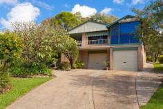  1 Churinga Pl Coffs Harbour NSW 2450 Located in a quiet cul-de-sac, this attractive blonde brick property enjoys a leafy, tranquil aspect. With plenty of visiting birdlife, it's hard to believe it's just a few minutes drive from here into the CBD. A much sought-after location tightly-held by great neighbours, you can count the number of homes on one hand. Set back from the street on a generous 1353sqm block, with a lovely front garden affording privacy, the home has two garages, along with the bonus of under-house storage and a workshop area.  While there's also plenty of additional off-street parking, a big plus is the concrete side driveway leading to the covered carport at the rear - perfect to store the boat or extra vehicles. And behind this section is a garden and even more land: there's potential to retain the double garage for the main house and use the separate carport as a garage for a possible second building (subject to Council approval). Side stairs lead to a wide, tiled wrap-around verandah, the perfect late afternoon spot to enjoy the views with a glass of wine and cheese platter. Tastefully renovated interiors which maintain the warmth and character of the home add to the appeal of the open plan living and dining room, which has lovely timber flooring and air conditioning. The adjoining sunroom is accessed through French doors, and windows on three sides offer the perfect location to sit back and relax with a book or magazine. Slate-look flooring in the kitchen is soft underfoot, and this entire space has had a contemporary renovation by Hi-Tech Kitchens just nine months ago. Streamlined and practical, with plenty of cupboard and bench space, the kitchen features a double pantry, integrated Electrolux microwave and oven and a ceramic cook top. A Euro dishwasher is another addition here. With a practical and spacious floor plan, all three bedrooms run off a long hallway, with double linen storage and a hide-away laundry behind cupboard doors at the far end. The master bedroom features big windows, mirrored robes and a modern ensuite with a crisp white colour scheme. Both this room and the second bedroom have soft carpet underfoot, while the third bedroom has timber floorboards. The generous main bathroom has a large frosted window that allows light to flood into the space without compromising privacy, and it also incorporates a freestanding vanity. The hall flows out to another fabulous spot for entertaining, with a sun-drenched outdoor area with a generous curved seating area. Throw down an assortment of chair pads here and you'll have plenty of room for your guests or extended family to enjoy the elevated rear garden. This is a beautiful spot to enjoy the warm winter sun, or pop up an umbrella in summer for your afternoon barbecue. Beyond the carport is a quiet garden with established azaleas, frangipani, bottlebrush and palms, all which add to the tranquil feeling of the property as well as offering privacy.  Tastefully renovated, practical, with a large block, double garaging plus side access and a carport, this property is beautifully presented and has great overall appeal. Throw in the fact that it's just a couple of minutes to the CBD by car (with the option of strolling into town) and this lovely home is hard to beat. *Renovated, private home with lovely views. *Two garages + concrete side driveway to separate carport. *Contemporary new kitchen, timber floorboards, lovely sunroom.  *Quiet cul-de-sac location close to town. www.unre.com.au/chu1 Follow us on Twitter: Unrealonline RATES: $2440.49	LAND SIZE: 1353 sqm Whilst every care has been taken in respect of the information contained herein no warranty is given as to the accuracy and prospective purchasers should rely on their own enquiries. 