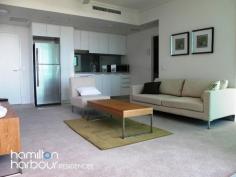 11403 8 Harbour Rd HAMILTON Qld 4007 This modern one bedroom apartment is perfectly situated in the heart of the prestigious Hamilton vicinity boasting resort style living including an infinity pool and barbecue area set amongst lush tropical gardens. This one bedroom apartment has a real sense of space with its floor to ceiling glazing showcasing the suburban views of Ascot and Hamilton. At the centre of the open plan design, lies the linear style kitchen. Its contemporary design is ideally matched with quality appliances. The alfresco balcony is perfect for entertaining. The innovative bi-fold windows ensures that this area can be used in all weather types and provides a separate dining area. The queen sized bedroom features mirrored built in wardrobes with blockout blinds. In the bathroom you'll find a stone topped vanity and quality fixtures. The apartment is also wired with fibre optic cabling to keep your apartment abreast of advances in communication and entertainment technology, well into the future. Offering an abundance of accessible shops within the precinct including Woolworths, Domino's Pizza, Coffee Club, Shinzhen Sushi to name a few and a 3 minute walk to Portside Wharf and Racecourse Road Village, the location is perfect. 