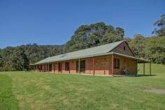  82-84 Old Cedar Track, YELLOW ROCK NSW 2527 Cedar Ridge - Simply Amazing Views House on Acreage - Property ID: 714858 Perched high on Cedar Ridge on 70 acres this home (lifestyle) is designed to take in the awesome views over Albion Park and looking right across Lake Illawarra.  "Simply amazing views!" The main home features a massive wrap around bull nose verandah keeping the home cool in summer and warm in winter and to be honest just giving that country ranch style living. The home is massive and open with the owner successfully capturing loads of natural light with classy oversized windows and high 2.7 meter ceilings. The massive kitchen boasts walk in pantry, huge stove/oven and opens onto a 10 metre long family and dining room so you can entertain with family and friends close by. You won't miss the 6 x 8 meter living/billiard room with huge fire place. Main bedroom is huge with ensuite and corner spa, separate shower and large walk in robe. And like any true farm house the laundry features an additional shower/toilet "mud room" to clean up after an enjoyable day on farm.Three more rooms in main home have built in robes and average 3.2 x 3.6 metres ducted cooling/heating throughout.  The second home "Weekend Retreat" started its life as a huge shed and was modified as a 3 bedroom weekender while the main home was built. This home is a full home and so country, filled with charm. The large open kitchen boasts a wood cooker that heats the water also yes back up hot water available! Open plan living off kitchen and 3 full sized rooms with built in robes. Great views once again from this home with its own fenced in country yard - reminds me of a bed and breakfast cottage home. Water is supplied from a gravity feed from the natural water fall and has never run out, stored in a 20,000 gallon tank. Yes, there is electricity and seep away sewerage. Austar and television in all rooms.  Approximately 20 acres cleared maybe more and huge potential to clear more. This property is a lifestyle and a hobby farm, cows graze leisurely, I think I even saw the pig and cow out of babe looking in the house window! Incredibly private, warm and just so worth an inspection, it may just change your life.  Why will you love this home? A few notes from the owner ...  o 	 The peace and quite giving the feeling that we live out in the country, yet are less than 10mins from Albion Park town centre, 15 mins to the freeway and railway station. Giving us the best of both worlds. o 	 We love the wake up call from the birds, and the abundance of wild life. o 	 The spectacular view over Lake Illawarra and surrounding suburbs. o 	 This is a very secure area to live, its "Paradise" Council Rates: $2,774.84 p/a approx Zoning: E3 Environment Management Land Area: 27.9700 hectares Contact Robb Grubb 0411 315 450 or 42266772 for a private viewing or come along to our next open. All information contained within this advertisement is gathered from sources Professionals Wollongong believe to be reliable. Professionals Wollongong cannot however guarantee its accuracy and interested parties should make and rely on their own enquiries.   Print Brochure Email Alerts Features  Land Size Approx. - 27.97 hectares 