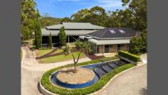 54 Lane Cove Rd Ingleside NSW 2101 Drive through the secure gated entry and wind your way past timber post and rail paddocks and cascading waterfall to the residence. From the moment you lay eyes on the exquisitely crafted faade it becomes immediately apparent that this residence is of the highest calibre. Exquisitely crafted from sandstone and wrapped in a timber posted bull-nose verandah with a large turret romancing the faade, it tastefully fuses Australian colonial and European provincial themes with designer finishes to create a retreat of elegance and sophistication with a warm country-style ambiance.Guests are welcomed in a grand formal entrance foyer with soaring double height ceilings, an elaborate antique chandelier lighting the way. The living spaces have been cleverly interwoven to integrate with an enormous indoor/outdoor loggia with an open fireplace and separate living and dining areas that merge seamlessly with level lawns and soaks in the north easterly sun, summer breezes and sweeping views. It comes complete with formal living and dining spaces plus an enormous family room or home cinema with surround sound and mounted flat screen TV. Finished in imported Italian marble with a breakfast bar and state-of-the-art European appliances, the kitchen is equipped with a commercial-grade gas stove with barbecue plate and two ovens, two integrated dishwashers and pantry. Each of the bedrooms is king-sized and come complete with built-in wardrobes and 7 with ensuites. The palatial master bedroom forms the heart of a circular turret and features towering ceilings, dressing room, ensuite, wardrobes built-into the circular wall, spiral staircase leading to a circular mezzanine library plus access to a vast sun drenched terrace with spectacular views. Absolute heaven for the dedicated wine connoisseur, the wine cellar is locked behind wrought iron gates and consists of a labyrinth of sandstone walled rooms with cedar wine racks holding up to 4,000 bottles as well as a bar plus dishwasher and a cool room.For the equine enthusiasts there is a rubber indoor arena with lighting, modern stables and yards for 7 horses plus a caretakers office, tack room, feed room and wash bay and 9 post and rail paddocks.