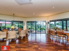  23 Walden Close Gidgegannup WA 6083 Inspections Inspections by appointment only. This rural and much sought after village on the edge of metropolitan Perth, has many superb life styles to offer. This 6.2 acre property would have to be classified as your own piece of paradise, secluded and far away from the maddening crowd with the hustle bustle of the city. It borders other large properties with one great neighbour, Please allow me to give you a little tour, starting with pines and an electric gate/intercom, a welcoming feature on wet and windy days. The 150 metre trees and shrubs lined driveway brings you to a large parking area, a double car port and double shaded parking. A lovely elevated home, flanked by bush further compliments this great setting. The pond, the sound of 3 waterfalls, lush green rockery and a backdrop of unique and unusual panels, gives the outdoor entertaining area a special feel. Open living with 180 degrees views over a native garden, bushes and trees that seem to ramble on into the distance over this gently sloping property. The split kitchen is a cook’s dream where dirty dishes and evidence of a great meal are hidden from view by a low curved feature wall. It also features a new gas cook top, electric oven. The property boasts a large master bedroom with private ensuite and walk-in-robe as well as a large double guest bedroom and a smaller double bedroom both with built-in-robes. There is also a office/single bedroom overlooking this amazing property. The main bathroom is large and is beautifully presented with a spa/shower and toilet. The pristine jarrah flooring flows through the home and along an extra wide passage way with bookcase. The high ceilings, tinted windows throughout and the cosy wood fire resonate the perfect setting to unwind and enjoy the stunning views from this beautiful property whilst reading, relaxing with family or entertaining. A solar hot water system with gas booster and a solar tracker run endless hot water to the property using the sun hitting the large roof span to reduce your electricity costs. Outside the property features a wrap-around verandah for relaxing and taking in the breathtaking sunsets. The property is also fire ready with permanent gutter guard, 24m span large sprinklers, extra-large electric cable, firefighting pump and hose and 12000L and 150000L water tanks. Hundreds of graceful grass trees (black boys) some ancient surround the home, together with the many shrubs and trees that make this property lush and green all year round. A small path meanders through the bush to a netted vegetable garden, 2 open patches and a 6m x 3m potting shed with electricity. Next to this is a 12000L water tank fed by a 600 gallon an hour bore for watering with a new pump. Currently three quarters of the property is reticulated with automated sprinklers and a float switch regulates the water level. There is another 6m x 3m workshop also with electricity, a work bench and shelving on both sides for storage. Then there is a 6m x 3m ventilated storage shed. Just down a slope your eye will catch citrus and exotic fruit trees as well as 2 almonds, and a pecan tree, all artistically netted and weed protected by a weed matt and top dressed with very fine gravel. Further down a chicken coop, enclosed to make it fox proof and house on stilts, with easy access to eggs. This is part of a larger open enclosure, ideal for geese, ducks, goats etc. A circular driveway leads to steps and a 150.000 Lt. rain-water tank that sits on the other side of the house together with more netted exotic fruit like, Jube-Jube , Persimmon, Pawpaw, Pomegranate and another Shartoot all hidden from view. Jezzabelle the pet kangaroo was brought up in the house and considers this her home. She will delight you when she comes to feed with her current joey. Wild ones will come down in the hot summer to feed at the kangaroo patch just below the house which is kept green with two large sprinklers. There are several great secluded spots to sit with a book overlooking a dam across the bridle path or you might enjoy the green rolling pastures across the fire break. Close to the house is a great spot for a fixture or an umbrella and some chairs, marvelling at the lovely view, bush orchids and wild flowers. This area is ideal for entertaining with friends or family. There is ample room for a pool or to keep animals. The local schools at Mt Helena are only a few kilometres away and there is a bus stop 100 metres from the front gate of the property. • If you are ready to make the tree change and looking for seclusion and nature at its best, waking up to the sound of kookaburra’s.  • If you marvel at the sight of an eagle soaring high in a clear blue sky or watch a flock of red tailed cockatoo’s resting in their favourite tree.  • If you like to be surprised by a bobtail wondering past or like to surprise a sleeping sun drenched goanna on the driveway.  • If you like to spot an unsuspecting bandicoot or get excited by a heron, gingerly negotiating rocks to snatch a fish from the pond.  • If you enjoy watching galas, twenty eights and magpies or beautiful bright blue wrens all vying for position at the feeder just outside the window.  THEN THIS CAN ALL BE YOUR INSTANT PRIDE AND JOY. The owners have lovingly spent many years of dedication to this once virgin piece of land which has so much to offer that no photo or description would do justice to the magic that surrounds you here. 