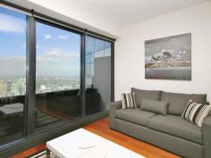  6003/7 Riverside Quay Southbank VIC 3006 Maximising wraparound Albert Park, MCG, Botanical Garden views to bay view, this resort style skyhome reveals a scenic retreat graced with a cleverly integrated in/outdoor design to bask in the vibrancy of Melbourne from each and every window.  The defined living and dining areas capture picture views and soak up an abundance of natural light. An open granite kitchen is equipped with Miele appliances and seamless cabinetry.  Residents enjoy access to a premier selection of facilities including a gymnasium, pool, sauna, private cinema, 24 hour concierge and video intercom and lift access.  The double-sized bedroom includes wide built-in wardrobes and direct access to a stylish ensuite. Additional features include a separated laundry, guest powder room, ducted air conditioning, chic downlights and single carport. It represents a remarkable investment opportunity for those seeking an unparalleled lifestyle location with popular demand and a high rental yield.  It is proudly set on the 60th floor and enviably located within easy walking distance to sports venues, Crown Casino, Arts precinct, Southbank shops, cafs, restaurants and transport options. 	 