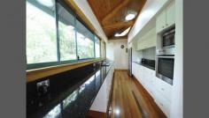  108 Charles St Iluka NSW 2466 ARCHITECTURE IN NATURE Architect designed home surrounded by rainforest and Australian flora. Positioned to capture coastal breezes with large private decks for entertaining. Adjustable louvres and well positioned windows ensure natural airflow throughout. With natural local timbers in the ceiling and floors this home emulates a warm feeling, along with a galley style kitchen and one bedroom most of the living is upstairs, with the additional bedrooms and study downstairs.  Situated just 80 metres from the river and 1km to the beach and local shops. This is a must see for those requiring privacy with elegance. 