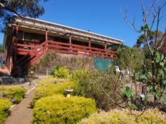  54 Signal Hill Road, Dodges Ferry, Tas 7173 Beautiful Home - Beautiful Price Everywhere you look and everywhere you walk there is something to catch your eye, something to capture your imagination and somewhere to sit and ponder or meditate. The superb landscaped grounds are inviting, the spectacular views are just breathtaking and the man of the house has a choice of sheds to potter in.  A large circular driveway, a massive triple bay garage and a driveway to the bottom of the yard where there are more sheds. A magnificent approx. 12 metre long entertainers deck with bistro blinds for year round use... and this all before you get into the house.  Park in the carport and gain access to the home through the front entry. Welcome to a warm and inviting split level home, with the living areas all on the bottom level making full use of the spectacular views and the bedrooms all on the upper level and looking out onto landscaped front gardens. A modern solid wood kitchen, lovely dining area with sliding doors to the deck and a cosy lounge room kept warm by wood heater, all enjoy views from Seven Mile Beach, to Lewisham and Mt Wellington. The three bedrooms are a nice size, two with built-in robes and all finished off with quality blinds and drapes. This is the complete package and brilliantly priced. 