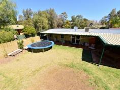  4 Beefwood Court Sadadeen NT 0870 Family Home and Studio Nestled on a 1020 sqm2 allotment in a peaceful cul de sac in a family friendly neighbourhood with a lovely park nearby. This lovely home offers multiple living spaces and modern living for the family with a park is nearby for your enjoyment.  As you enter the home you will be impressed with open plan central living area which feature French doors that lead out to the fabulous outdoor undercover entertaining area. The contemporary gas kitchen is adjacent to this room and is ideal for the keen chef, with plenty of bench and cupboard space. There is a cosy second living area off the kitchen as well as a bedroom and the main bathroom. The other three bedrooms feature built in robes and the main bedroom features a bay window a lovely ensuite with spa bath, separate shower. A combined self-contained studio /workshop is located in the back yard and features a guest bedroom, small kitchenette and bathroom. There is scope to develop this further with rental possibilities. Additional features comprise of undercover parking, solar hot water, a combination of ducted evaporative air-conditioning and reverse cycle air cooling and under cover car parking for three cars. 