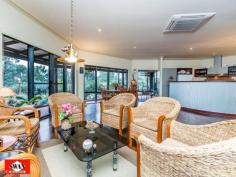  23 Walden Close Gidgegannup WA 6083 Inspections Inspections by appointment only. This rural and much sought after village on the edge of metropolitan Perth, has many superb life styles to offer. This 6.2 acre property would have to be classified as your own piece of paradise, secluded and far away from the maddening crowd with the hustle bustle of the city. It borders other large properties with one great neighbour, Please allow me to give you a little tour, starting with pines and an electric gate/intercom, a welcoming feature on wet and windy days. The 150 metre trees and shrubs lined driveway brings you to a large parking area, a double car port and double shaded parking. A lovely elevated home, flanked by bush further compliments this great setting. The pond, the sound of 3 waterfalls, lush green rockery and a backdrop of unique and unusual panels, gives the outdoor entertaining area a special feel. Open living with 180 degrees views over a native garden, bushes and trees that seem to ramble on into the distance over this gently sloping property. The split kitchen is a cook’s dream where dirty dishes and evidence of a great meal are hidden from view by a low curved feature wall. It also features a new gas cook top, electric oven. The property boasts a large master bedroom with private ensuite and walk-in-robe as well as a large double guest bedroom and a smaller double bedroom both with built-in-robes. There is also a office/single bedroom overlooking this amazing property. The main bathroom is large and is beautifully presented with a spa/shower and toilet. The pristine jarrah flooring flows through the home and along an extra wide passage way with bookcase. The high ceilings, tinted windows throughout and the cosy wood fire resonate the perfect setting to unwind and enjoy the stunning views from this beautiful property whilst reading, relaxing with family or entertaining. A solar hot water system with gas booster and a solar tracker run endless hot water to the property using the sun hitting the large roof span to reduce your electricity costs. Outside the property features a wrap-around verandah for relaxing and taking in the breathtaking sunsets. The property is also fire ready with permanent gutter guard, 24m span large sprinklers, extra-large electric cable, firefighting pump and hose and 12000L and 150000L water tanks. Hundreds of graceful grass trees (black boys) some ancient surround the home, together with the many shrubs and trees that make this property lush and green all year round. A small path meanders through the bush to a netted vegetable garden, 2 open patches and a 6m x 3m potting shed with electricity. Next to this is a 12000L water tank fed by a 600 gallon an hour bore for watering with a new pump. Currently three quarters of the property is reticulated with automated sprinklers and a float switch regulates the water level. There is another 6m x 3m workshop also with electricity, a work bench and shelving on both sides for storage. Then there is a 6m x 3m ventilated storage shed. Just down a slope your eye will catch citrus and exotic fruit trees as well as 2 almonds, and a pecan tree, all artistically netted and weed protected by a weed matt and top dressed with very fine gravel. Further down a chicken coop, enclosed to make it fox proof and house on stilts, with easy access to eggs. This is part of a larger open enclosure, ideal for geese, ducks, goats etc. A circular driveway leads to steps and a 150.000 Lt. rain-water tank that sits on the other side of the house together with more netted exotic fruit like, Jube-Jube , Persimmon, Pawpaw, Pomegranate and another Shartoot all hidden from view. Jezzabelle the pet kangaroo was brought up in the house and considers this her home. She will delight you when she comes to feed with her current joey. Wild ones will come down in the hot summer to feed at the kangaroo patch just below the house which is kept green with two large sprinklers. There are several great secluded spots to sit with a book overlooking a dam across the bridle path or you might enjoy the green rolling pastures across the fire break. Close to the house is a great spot for a fixture or an umbrella and some chairs, marvelling at the lovely view, bush orchids and wild flowers. This area is ideal for entertaining with friends or family. There is ample room for a pool or to keep animals. The local schools at Mt Helena are only a few kilometres away and there is a bus stop 100 metres from the front gate of the property. • If you are ready to make the tree change and looking for seclusion and nature at its best, waking up to the sound of kookaburra’s.  • If you marvel at the sight of an eagle soaring high in a clear blue sky or watch a flock of red tailed cockatoo’s resting in their favourite tree.  • If you like to be surprised by a bobtail wondering past or like to surprise a sleeping sun drenched goanna on the driveway.  • If you like to spot an unsuspecting bandicoot or get excited by a heron, gingerly negotiating rocks to snatch a fish from the pond.  • If you enjoy watching galas, twenty eights and magpies or beautiful bright blue wrens all vying for position at the feeder just outside the window.  THEN THIS CAN ALL BE YOUR INSTANT PRIDE AND JOY. The owners have lovingly spent many years of dedication to this once virgin piece of land which has so much to offer that no photo or description would do justice to the magic that surrounds you here. 