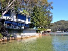  18-20 Sturdee Lane Lovett Bay NSW 2105 Laffing Waters ONLY TRUE NORTH facing waterfront Pittwater property on two titles with facility for 70' + boat. A waterfront property over 29 meters with sandy beach and features; Built over waters edge to the highest standard with amazing 180 degree views of Pittwater to Palm Beach, with sun all day in winter, and the north easterly sea breeze in summer. An amazing home that must be seen to be appreciated. * Ground floor features a modern kitchen, granite bench tops, Miele appliances and abundance of cupboard space. The open plan dining and lounge have sliding floor to ceiling windows open out onto a large cantilevered balcony over the water, plus a designer wood burning fire place. * Master bedroom with ensuite and spa, built-in robes, sitting room and adjoining study all with brilliant water views, a further two bedrooms and ensuite also with water views. * Self contained king size cabin with ensuite, surrounded by landscaped gardens, a separate alfresco dining pavilion with Danish wood burning fireplace. * Reverse cycle ducted / zoned air conditioning, town water, auto sprinkler system. General Features Property Type: House Bedrooms: 4 Bathrooms: 3 Indoor Features Ensuite: 1 Study Other Features Fireplace, Jetty, Storage, Waterfront, Waterview 