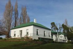  5283 Bass Hwy Deloraine TAS 7304 Classic Country Homestead with a Twist Set on ten lush acres of prime soil for grazing sits this extra-large country residence. The original Georgian style period home Hilltop was built in 1847 with the large additional wing being added in the 1950’s and matches in beautifully with the original homestead. Large and spacious the home consists of 4 to 5 bedrooms, office, study, massive formal living room, sitting room, updated main bathroom with additional bathroom and kitchen ideal for guests, large open plan main country kitchen, double garage with remote access under as well as twin cellars. Out buildings are a plenty here to with three bay vehicle/implement garaging with a joining storage/workshop, an old dairy that has been converted into stables, large barn and poultry run. The beautiful gardens are full of colour in spring and the property is around the home has been planted out with many old well established exotic trees, English box hedges and shrubs adorn the home and the majestic driveway is lined with large vibrant poplar trees. This fantastic lifestyle property would be Ideal for the extended family looking for a tree change or would be easily and ideally converted to a guest house/B&B (STCA). All this and so much more located just five minutes’ drive to the beautiful tourist town of Deloraine where all major services are available and only forty minutes to either Launceston City to the North or Devonport City to the West.                               Inspections strictly by appointment only, to move forward with yours call me now. 