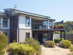  Bermagui NSW 2546 Stunning townhouse designed for maximum interaction with a beachside ecosystem. 3 bedrooms, 2 bathrooms and separate toilet, with luxury fittings throughout and panoramic ocean, sand dune and Gulaga (Mt Dromedary) views from sliding glass doors and deck. Enjoy the private solar heated lap pool, take a boardwalk through the wetland and dunes to secluded Moorhead's Beach or stroll to a riverside cafe for coffee or sushi. Sylish coastal living in a stunning setting. 