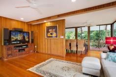 3 Longden St Brinsmead QLD 4870 This elegant stylish home offers the feeling of seclusion being tucked away on a 1556m2 block with a stunning rainforest backdrop. The home itself is layered over three levels with the first living floor being the masterpiece of the house featuring beautiful timber floors which flow onto both front and rear timber decking. Both verandas running the full length of the house with the rear veranda boasting large architectural style cathedral ceilings adding to the wow factor of this home. The living level consists of two separate lounge areas, the fourth bedroom which is ideal for a home office/business with separate front access, bathroom, dinning and a modernised kitchen with gas cooking perfectly situated in the centre of attention, ideal for entertaining. Enjoy a near complete, panoramic view of the lush greenery from the numerous glass windows and doors bringing the outdoors inside. 