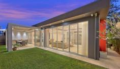 5 Goodwin Street Narrabeen Designed by highly celebrated Architect, Gartner Trovato, we take 
pleasure in presenting a residence where no expense has been spared, a 
creation that delivers a magnificent beach home that is simply 
overflowing with modern design cues, easy functionality and a stream of 
luxurious, hotel quality features and finishes. 
 Step through a grand entry to be immersed in a soothing palette of 
cocooning colours, luxurious materials and natural flowing light which 
showcase contemporary travertine flooring and sky high ceilings, fully 
enhanced by floor to ceiling, energy efficient glass. With the entry 
level focussing heavily on lifestyle and entertainment, the natural 
indoor to outdoor flow is one of many factors that make this property 
irresistible, with a mesmerising in-ground pool acting as a centrepiece 
for all to admire and enjoy. 
 A sequence of entertaining zones embellish this residence, each more 
beautiful than the last, with an arrangement of backdrops created to 
capture ever single aspect of contemporary brilliance. Wide, open 
planned design and clever integration of sleek, glass opening doors sees
 these living and dining spaces integrate into one, collaborating the 
indoors with the out, where one can enjoy a perfect Northern aspect 
together with additional designer features which cleverly incorporate an
 eco-fireplace, ducted zoned air conditioning plus multi-media smart 
wiring capabilities. 