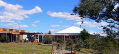  149 Halls Rd Taralga NSW 2580 The rustic stone drive takes you to the top of the hill where you will be amazed at the views. The sturdy 3 bedroom structure offers security & is Council approved. The main bedroom has an ensuite & a nursery or dressing room. The kitchen, dining & lounge are open plan with a rural outlook. Relax on the wrap around enclosed verandah with family & friends or play a couple of ends on the tennis court. There’s a large double garage with workshop, a secure machinery shed & an additional double garage for storage. A permanent creek runs through the property which compliments the rich basalt soil. Take pride in owning this wonderful property by being the first to inspect, ring now.   Features Built-In WardrobesEn-suiteFloor BoardsFully FencedShedVerandahWater TankWorkshop 