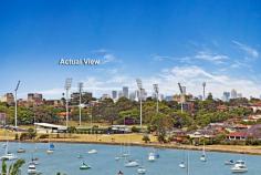  54A Burns Crescent Chiswick NSW 2046 sophisticated offering of unquestionable quality and refinement in a 
blue ribbon harbourside setting, this breathtaking residence is quite 
simply beyond compare. Flowing over three levels and finished to the 
highest of standards, panoramic views stretch across the bay to the 
distant skylines of North Sydney and the CBD. Occupying an elevated 
setting that embraces privacy and tranquillity and flooded with natural 
northern light throughout, this family home is designed for easy, low 
maintenance entertaining. An ultra-contemporary masterpiece of rare 
quality, it is minutes to parks and village life. 	Bright split level lounge and dining area, featuring in/outdoor ponds 	Marble tiled entertaining terrace, BBQ outlet and roof top garden 	Separate family room and theatre room / 4th bedroom with ensuite 	Generous master with walk-in robe, unique open ensuite with views 	Deluxe kitchen, CaesarStone island bench and glass splash-backs Sun-washed rear courtyard, sparkling lap pool with water feature Gas fireplace, heated tiled floor, polished timber and ducted air con y