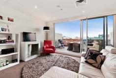  105/18 Bent Street Kensington VIC 3031 Luxury and Lifestyle with Spectacular City Views This stunning two bedroom apartment within “The Kensington” boutique complex, epitomises everything urban living represents, boasting an ideal city fringe location, generous open floor plan and contemporary, elegant design. Bathed in natural light, a central gourmet kitchen separates dining and lounge, spilling seamlessly onto a huge entertainer's balcony with spectacular, sweeping city views. Stone wrapped island/meals and bench tops, luxury stainless steel Smeg appliances, glass splashback, pull out pantry and soft close Hettich drawers feature in the crisp, white kitchen, whilst the lounge boasts a sleek, minimalist fireplace. Two large double bedrooms with generous built-in robes, deluxe master with spacious fully tiled ensuite including bath, and a large private balcony, also with city views, provide excellent accommodation. Safety and ambience have been incorporated with central video surveillance, intercom, secure building and underground carpark (with storage) entry and a landscaped, elevated garden in the enormous complex courtyard. Other impressive features include reserve cycle air conditioning, quality carpets, tiles and timber flooring. General Features Property Type: Apartment Bedrooms: 2 Bathrooms: 2 Outdoor Features Carport Spaces: 1 