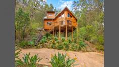  5964 Wisemans Ferry Rd Dharug National Park Gunderman NSW 2775 We believe this wonderful Appalachian Log' home truly has the WOW factor and all the varying lines of the Cathedral Ceilings somehow is inspirational! This home is a Temple' featuring 3 bedrooms (as follows:-) Two large bedrooms downstairs (with built-ins) and a huge mezzanine' Loft that is versatile in as much it could be a wonderful Loft Studio' and huge Master Bedroom or just a huge Loft/Studio, overlooking the living area below from the Balustrade (again what an effect) or just as a Studio! The Kitchen is large, well thought out and of a complimentary design. A huge open plan living/dining area with magnificent views to the Hawkesbury River. This unique hide-away' property is blessed with fabulous River and Bush views, set in its majesty above the World' and yet has an excellent driveway access with ample parking for 3+ Cars and an easy turn-around area. The land area is 986m2 (approx.) of bush-land paradise with this beautiful home perfectly set in its surroundings with the National Park behind. Approx 12kms from Wisemans Ferry overlooking the picturesque Hawkesbury River and roughly only 50mins to Gosford and Hornsby. Rates: $1,045 per year. 