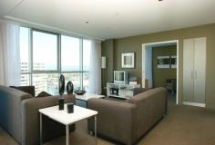  Surfers Paradise, QLD 4217 Ocean & Broadbeach Views Here is an opportunity to own a prestigious 2 bedroom (1+1) apartment in a stunning 30 level Raptis high-rise.  Each apartment has ducted personal control air-conditioning, spacious open plan living areas and generous balconies. The kitchens are fully equipped with quality European appliances. You will notice the high standard of finishes and inclusions throughout as well as acoustic treatments which exceeds Australian standards.  Facilities - Lifestyle and Recreation:  - Private theatre room for resident use  - Heated indoor merging outdoor swimming pool  - Spa  - Sauna  - Steam room  - Fully equipped gymnasium  - Virtual Golf simulation games room  - Poolside barbeque and entertainment area  Location:  - Located beachside in Surfers Paradise, 150 metres from the beach  - Contemporary design  - Ageless quality  - Sculptural form  - Lush tranquil landscaped gardens synonymous with Raptis developments  - Elegant entry with exclusive facilities to complete a quality lifestyle  - An easy stroll to Surfers Paradise shopping precinct and night life  - Minutes to Casino, Pacific Fair and the new Gold Coast Convention Centre. 
