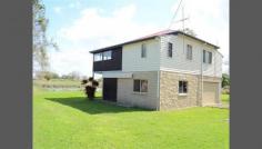  1 Bridge St Lawrence NSW 2460 Situated on the banks of the Clarence River in the peaceful village of Lawrence is this true riverside gem. The home stands on an elevated and enclosed brick foundation offering solidarity and maximizing on a truly unique position. At the base of the house is the large double garage and workshop space with power, lighting, concreted floor and electric roller door. A staircase on the western side of the home leads to the covered and enclosed balcony that overlooks the river. Upstairs are three comfortable bedrooms with carpeted floors. The Master bedroom fronts onto the balcony and has a sliding door providing easy access to it. The dinning and living areas are spacious with the timber floors and tall ceilings offering a homely feeling. The dining room faces and opens onto the balcony and will surely make summer barbecues easy. The kitchen also looks out to the river and is well lit and uncomplicated offering ample storage and prep space. The country style bathroom is also well lit and offers a three way configuration with separate bath, shower, vanity and toilet. 