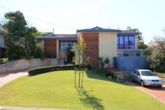  13 MACCABEAN AVENUE , DIANELLA WA 6059 OPEN SATURDAY 8th Nov 12 -12.30pm Set on 781 sqm of prime real estate, this charming home oozes natural light and huge potential. From the main entrance you walk through to the airy and open lounge room adorned with French Wooden windows and doors to let the natural light and elevated view stream in. The spacious open plan Tasmanian Oak kitchen overlooks the meals and living room which leads onto the private and luscious back garden complete with birds and trees and an all season covered alfresco. The home has been designed around capturing the elevated views of the Perth hills with balconies on all the front rooms. $909,000 to $949,000 