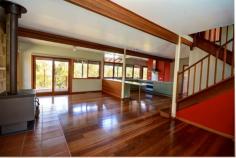  5 Centennial Glen Rd Blackheath NSW 2785 Feel immediately at home as you step into this beautiful property, designed to make the very best of its peaceful bushland location. Windows are a great feature of this gorgeous home, flooding the space with light and offering picturesque outlooks from every one of treetops & bushscapes. From the tiled spacious entry to the sandstone feature wall in the living room, wide board hardwood floors, generous kitchen with large pantry, soaring windows, spa bath, central & slow combustion heating - it's obvious comfort & beauty has not been left to chance here. And there are outdoor spaces for all the seasons with decks on both sides, the front one catching the sunsets. Upstairs the three bedrooms and a bathroom are delightful with vaulted ceilings and large dormer windows and window benches. There is a large lock up garage, heaps of storage space and the scribbly gum bush garden is low maintenance. All this peace & beauty is within 20 minutes walk from town and in close proximity to some of the most magnificent bush walks & climbing spots in Blackheath! 