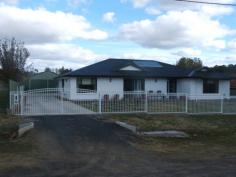 Glen Innes
NSW
2370 Come with me through the front gate of this luxurious designer home. The privacy is immediately noticeable as there is a colourbond fence surrounding this property with a feature aluminum front fence. The concrete drive way leads you to the rear colourbond double garage/workshop which has electricity and is fitted out with power points. The concrete extends to the rear of the house giving it an extra decking area plus a concrete pathway to the rotary clothes hoist. The front of the building has a concrete and tiled decking landing to the entrance. Upon entry one can immediately feel the warmth and luxury of this home. You enter this beautiful home into a very spacious open plan living/dining and gourmet kitchen area which has an extensive work bench with cupboards/dishwasher and front display cabinet. Other kitchen features include long extensive wall cabinets with electric cook tops, wall oven, range hood, spacious pantry and microwave shelving. $470,000 