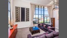  7 Manakoora Rise, Sorrento, WA 6020 From $1,849,000 Situated on an elevated 785m2 block in one of Sorrento's exclusive enclaves, this 5-bedroom 3-bathroom two-storey family home with enclosed alfresco patio overlooks an easy-care reticulated garden complete with sparkling pool and captivating ocean views to Rottnest Island. The ground floor of this beautiful coastal home comprises a double-volume light-filled entrance with solid Jarrah floors leading into a formal lounge / dining room complete with double-volume floor-to-ceiling curtains. A prominent stairway leading to the first floor creates depth and space. Flowing from the entrance and formal lounge, the informal living area offers an open plan design complete with modern kitchen with Caesar stone bench-tops, dining room / breakfast bar and family room complete with a gas log fireplace. 