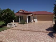  2 Madison Tce Roma QLD 4455 This wonderful home exudes luxury with generous living areas incorporating formal lounge/dining with adjoining spacious family space. The large modern kitchen features oodles of cupboard and bench space including walk in pantry, dishwasher and grocery window from garage. Big square tiles feature in the wide hallway and main living areas. The 3 huge bedrooms have built-ins. The main bedroom has luxurious ensuite and walk in robe and a screened sunroom where you sit and relax in the peaceful surrounds. Fully air conditioned home with a 9m x 7m, 2 bay remote controlled lockup garage, paved rear privacy fenced yard with garden shed plus established gardens. $595,000 