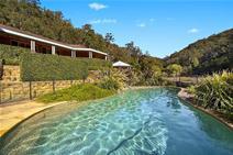  110 Rosehill Lane Yarramalong NSW 2259 LIFE STYLE FIT FOR A KING Central Coast hinterland nestled in the prestigious Yarramalong Valley, sits this master built north facing country style residence on 39 acres. With a relaxed indoor/outdoor living on a grand scale, the substantial executive estate offers a secluded and private location surrounded by established manicured gardens, a perfect blend of open fenced paddocks and timbered hillsides.  Close to the Yarramalong Village, Westfield Shopping centre, private schools, train stations, golf course and 45 minutes to Wahroonga this blue chip property also offers: A grand entrance, impeccable design and finely finished single level residence. Gallery style hallways with art lighting Soaring ceilings Formal study/library with combustion fire place, separate large TV room. Exceptional light filled open plan kitchen, dining and living all flowing onto north facing luxury style pool. Fully landscaped and fully fenced, outdoor living at its best. Supremely spacious layout with stunning views of the estate, all set in your own private valley. 6 spacious bedrooms, main with ensuite and walk through robe Home office ( work from home ) Abundant ... show more View Sold Properties for this Location View Auction Results General Features Property Type: Acreage/Semi-Rural Bedrooms: 6 Bathrooms: 3 Land Size: 15.78ha (39.00 acres) (approx) Outdoor Features Garage Spaces: 3 Offers Over $1,450,000 
