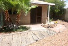  3-13 Battarbee St Araluen NT 0870 End unit in a small complex of only three, in an "all private" location. Body Corp fees shared so are very reasonable. This light bright solid and spacious unit has additional garden space and garage converted to study/additional living area. Both bedrooms are queen sized with built in robes. And there is a generous amount of additional storage in the wide passage. The bathroom has walk in shower, and full bath and vanity, with a convenient separate toilet. The large open plan living and dining areas are adjacent to the well equipped kitchen. The bench and storage space are generous and the convenient electric cook top is complimented with a wall oven and grill. Sliding door access allows for easy all weather outdoor entertaining in the neat paved and private patio. The garden is low maintenance and paved for child and pet security. The property may be sold furnished if required. (Furniture negotiable) 