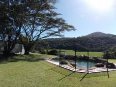  194 Gray Road Green Hill Qld 4865 33 Acres of Untouched Paradise just 20 minutes to the City As
 soon as I walked onto this property my mind went into a complete calm 
and I could think of nothing else but the vista in front of me. The 
green rolling hills blending into the rainforest on the outskirts, the 
fenced paddocks with sheds built waiting for the horses and the creek 
meandering through the middle. Little did I know it but there were 
still many more surprises all hidden away. We entered the 
rainforest which is national parkland, completely untouched and a whole 
new world. Wandering through I felt privileged as I am sure not many 
people would ever get the chance to experience the sheer beauty of this 
untouched world. The creeks running through all turned and twisted 
heading in different directions but each one more picturesque than the 
next. The huge trees had those trunks that are wide and sleek and you 
cannot help but appreciate their lines. The higher you go the more 
beautiful it is. Back into the land stretching in front of us we 
then drove to a higher area which gave a whole different perspective on 
the landscape and quite literally took my breath away. This would be 
the perfect place if someone wanted to build a new home or possibly a ... show more View Sold Properties for this Location View Auction Results 
