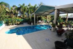  22-24 Tulloch Avenue Barmaryee QLD 4703 Massive home on 1 acre is an absolute bargain This 432m2, 5 bedroom home on 4217m2 corner block has everything plus privacy is assured behind security fencing with electronic gates. Also included is a 162m2 shed for dad, a pool for the kids & much more. Modern kitchen with stone benchtops, formal dining, family & lounge Wrap around verandah provides multiple outdoor entertaining areas  4 bay carport + undercover parking for caravan, boat, golf buggy & more Generous master suite with huge ensuite & wir/dressing room The home is fully airconditioned, has solar hot water and 5kw of solar panels Fully automated watering system with water supplied by tanks & bore Only a personal inspection will reveal everything this home has to offer but you need to inspect now as this home is priced well below replacement cost. General Features Property Type: House Bedrooms: 4 Bathrooms: 2 Land Size: 4000 m² (approx) Outdoor Features Garage Spaces: 12 Other Features Property Type: House House style: Lowset Construction: Brick Roof: Colour steel $699,000 