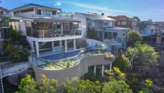  5 Highview Ave Queenscliff NSW 2096 An architectural triumph of the highest calibre, this as-new 
contemporary masterwork leaves nothing undone in its quest to provide 
the ultimate luxury retreat. Immersed in a sweeping 180 degree northerly
 panorama with stunning ocean views, its premier headland setting is 
within a few minutes stroll of the beach and village. Tri-level full brick residence with every conceivable luxury Vast open living, dining and family area with gas fireplace Glass bi-fold doors open to in/outdoor entertainers' deck Poolside family room with wet bar flows to covered patio Sophisticated Quantum Quartz island kitchen with butler's pantry Master suite with walk-in robe, ensuite and northerly deck Steam room, 3,000 bottle climate controlled wine cellar Chic bathrooms with heated underflooring, powder room Internal lift to all floors, Sydney red gum flooring, ducted air con Easycare garden with irrigation and automatic heated pool systems Stroll to Freshwater Beach and village, minutes from schools Double lock up garage, media centre, Dynalite smart system, comfort plus glass 