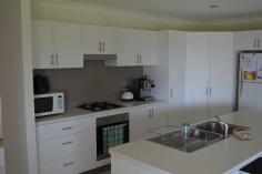  12 Highland Ridge Maclean NSW 2463 Motivated Seller Seeking A Motivated Buyer! This is a stylish and comfortable home situated in the most peaceful of neighbourhoods within Maclean. Three large bedrooms each with Built In Wardrobes ensure that your family's needs are well met. The Master Bedroom features a Walk-In-Robe and very practical ensuite, placing the height of privacy at your fingertips.  The kitchen could well serve even the most demanding of home chefs, with ample storage and preparation space. The well lit kitchen overlooks the equally well lit tiled dinning room. The carpeted family room is spacious featuring a recessed television cavity to maximize on the already very large space available. The incredibly modern bathroom has a glass shower screen that rises from the floor and the stall is tiled to the ceiling. Well manicured lawns and established gardens further add to homely feel of this unique property. You're vehicle accommodation is taken care of by a double garage with an electric roller door. The Large garage is where you'll also find the laundry with a bench with tiled splash back and stainless steel wash tub, an addition to avoid wastage of space in an already very spacious home. This is a home full of versatility and set to surprise. Currently tenanted and providing great returns, rent it out or enjoy it yourself either way call now for your inspection 