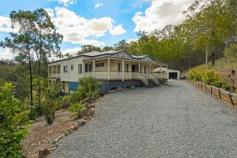  197 Tarata Rd Guanaba QLD 4210 ORGANIC ACREAGE WITH DUAL LIVING 
												
												
													Stylish Bluestone electric gates welcome you to your 
own little piece of paradise tucked away in the Gold Coast Hinterland 
found in the Guanaba Valley beneath Mt Tamborine. From the moment you 
step onto this amazing 7 acre property you will immediately get a calm 
sense of serenity. This fantastic elevated metal framed multi-level 
Queenslander is perched upon rolling acreage that has been re-vegetated 
with native plants, terraced gardens, citrus trees and a dam with 
Muscovy ducks and wild geese to match. If you are seeking a 
lifestyle change from the hustle and bustle of town to enjoy the simpler
 things in life, such as growing your own veggies and raising your own 
livestock, then this is the ultimate “tree-change” for you. With enough 
space for the kids/grandkids to ride bikes or ponies or to run a home 
operated business from the large 3 bay shed, 2 families could also 
easily combine here as the home has been designed with dual living in 
mind, all that needs adding is a kitchenette and you're set. Upstairs featuring: - Polished timber floors - Master bedroom with large en-suite and WIR - Beds 2 and 3 extra large size with BIR and study nook - Separate main bathroom - Extra-large separate carpeted formal lounge/dining room with beautiful French doors - Large open plan family/meals area adjoining kitchen and upper deck with fireplace for those cosy winter nights - White and modern 'country style' kitchen with ample storage and bench space, gas cooking and dishwasher - Timber deck overlooking property with plumbed in gas line for BBQ's - Air-conditioning throughout - Solar power (1.7kw) 