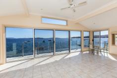 35 Nords Wharf Rd, Nords Wharf NSW 2281 FOR SALE:   OFFERS OVER $1,100,000   The new owners of this absolute waterfront home will feel like they are on holidays 52 weeks a year. Never a dull moment as you soak up the sun and watch the boats go by from your bedrooms and light filled living room. This deep water frontage property is ideal for the water lover with the owners having made extensive use of their 36ft cruiser over the years to enjoy the lake lifestyle. The owner advises the depth at the end of the jetty is over 5 feet. This has been a lifestyle weekender for its Sydney owners who have enjoyed all the property and Lake Macquarie has to offer for the past 18 years with many a feed of Flathead caught off the jetty. With easy access to both Sydney and Newcastle, this is the ideal private lake residence or weekend getaway. The split level home features oversized double garage with internal access, tiled entry foyer, main bathroom and three bedrooms two open onto the north facing deck overlooking the lake. The lower level features second bathroom and the laundry as well as a large kitchen with dishwasher and breakfast bar and big Open Plan living area that takes full advantage of the prevailing views and location. The basement area features tiled utility room with storage under the stairs and two boat sheds – one electric and one manual winch as well as a slipway and jetty. Set on over 770 square metres of land. This is for the active water lover, you will be hard pressed to find a home closer to the water. The owners will miss the School Holidays spent by the lake with the family and friends but its now time for new owners to enjoy the property. 