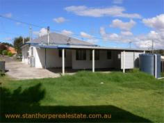 22 Granite St Stanthorpe QLD 4380 $185,000 4 bedroom low set residence Separate lounge Country style kitchen with gas stove & wood stove with wet back hot water system Modernized bathroom with shower Wood burning fire box  Large carport at rear plus a store room Rental? - $240 per week return Iron roof, rendered exterior, town water & sewerage Fully fenced ¼ acre allotment handy to town CBD and Quartpot Creek parklands This is a sturdy home with plenty of space and in a handy position. Category House Property ID H2999 