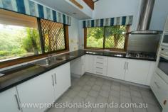  6 Outlook Cres Kuranda QLD 4881 $595,000 Almost 5 acres close to the Village House on Acreage - Property ID: 767789 This beautiful 4.7 acre property sits atop a hill at the end of a cul-de-sac and is only 5 minutes from Kuranda Village. Not far from shops and school for the kids. The property is fully fenced and is zoned rural residential so, you can keep a couple of horses or even some cows or goats. There are stables, a workshop and double shed to store feed or a vehicle. A permanent creek runs through the back boundary of this property to water the animals or even for a dip in summer! Wallabies graze on the grass and rest under the shady trees. The house is steel frame, hardy plank construction with 3 bedrooms, bathroom and ensuite off the master bedroom. There are built in wardrobes in all of the bedrooms. A recently renovated kitchen comes with a family size fridge. High ceilings, air-conditioning in the rooms and fans keep this house cool in summer. A combustion wood fired stove keeps the place warm in winter. In the afternoons you can sit on the timber deck enjoying a drink and the beautiful views of the rainforest on your property.  There is a small office, from which you could run your own business. A double carport is at the entrance to the house.  Solar panels have been installed on the roof and feed back to the grid. The Inverter is 5 kw The 26 panels are 6.5 Kw for extra performance It at times produces 35+ Kwh in a day Acreage properties close to town like this rarely come up for sale in Kuranda, so get in quick!  Print Brochure Email Alerts Features  Land Size Approx. - 1.76 hectares  4.7 acres  close to Kuranda VIllage  solar panels  permanent creek  mountain views  3 bedrooms 