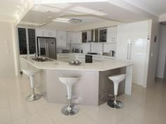  117 Cove Blvd River Heads QLD 4655 $579,000 Hard To Beat It would be hard to find better than this beautifully designed and presented home.  Enter through the impressive timber and glass door into the feature entrance hall that leads to open plan living and a modern 2-pac kitchen which has gas cook top and range hood, electric oven, twin dishwasher and stone worktops. The dining and family area has sweeping views of Fraser Island and there is a separate media room complete with surround sound system.  4 good sized bedrooms, the master having an extra large ensuite, walk in robe plus sliding doors leading to a private terrace with ocean views. The family bathroom has the wow factor with stylish fittings and stone top vanity. There is a good size laundry with plenty of storage. From the living area there are sliding doors to the large undercover entertaining area - a perfect place to relax and watch the sun go down.  A landscaped 2000m2 block with large 7x12m shed with power, light, shower and toilet plus a 2.7m high roller door - ideal for boat or caravan. There is also a double garage to the home with seamless flooring. The home has 1.8kw solar panels and a gas hot water system. Don't delay, phone today to arrange a viewing.   Property Snapshot  Property Type: House Features: Ensuite 