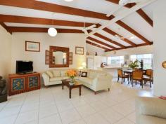  15 Agincourt St Port Douglas QLD 4877 $599,000  IMMACULATE FAMILY HOME WITH ROOM TO MOVE Picture perfect is how you will find this spacious Reef Park home that offers flexible living options to suit the entire family. The open, family friendly floor plan is split between the main three-bedroom, two-bathroom home and a very spacious one-bedroom, one-bathroom annex that lends itself to a number of possibilities including master suite, granny flat, teenager's retreat, private guest accommodation, or home office/business venture.  Complete with feature timber beams, the high raked ceiling in the home's main living area encourages the ingress of natural light and airflow while also providing a sense of space and openness.  This sense continues into the large, tastefully appointed kitchen that offers more than ample storage and bench space and a central hub for entertaining family and friends. All three bedrooms are very generous in their proportions, the master also featuring an expansive walk-in robe/dressing area and a very chic, very unexpected, bespoke ensuite. The quality tiling of the internal living areas flows out to the covered outdoor entertaining space that runs the full length of the home. Sharing this quality finish is the outdoor entertaining area of the annex that opens directly into the tropical inspired pool area, complete with cascading water fall. Outside, the more than 1000m2 allotment provides a combination of manicured grass and garden areas (including a number of fruit trees) intersected by the feature 'Sea Temple Stone' path that leads from the front of the home to the pool. Parking for three cars is also provided via a single carport and oversized double lock up garage with additional (separate) storage room. A slight configuration of the garden bed would also allow for the parking of a trailer, boat, or caravan. After 24 memorable years in Port our vendor has decided to make the move interstate, hence the opportunity to make this beautiful home your own. To arrange your private inspection, call Michael today.   Property Snapshot  Property Type: House Construction: Rendered Block Features: Air Conditioning Built-In-Robes Ceiling Fans Close to Schools Close to Shops/Restaurants Established Gardens Fenced Back Yard 