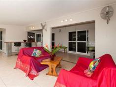  12 Ribbon Ave Port Douglas QLD 4877 TROPICAL, FUNKY & FUNCTIONAL A refreshing design allowing outdoor access from all bedrooms AND the main living area is one aspect of this practically designed family home.  The outdoor area itself combines depth and breadth under cover catching the late afternoon sun whilst looking to the uniquely shaped dark pebble crete pool with sumptuous waterfall to add to the relaxed feel. There is absolutely plenty of room for kids and pets to run and play whilst providing just enough garden space to enjoy the tropical feel whilst not creating major maintenance and if entertainment forms part of your life the oversized pool edge offers further foundation for seating, tables, bbq, shade sail or more. Internally the gourmet kitchen has been crafted with quality timber finishes and impressive stone tops combining frosted glass doors to house glassware and more. The appliances compliment the package that serves the open plan dining and lounge with convenience timber louvers for light and air flow. All air conditioned bedrooms offer storage via built in robes and both oversized bathrooms (shared or the master ensuite) impress with modern design young in age and high in practicality. Solar heats your water and further solar subsidises your power needs and keeps living costs to a minimum, perhaps even further the front garden vegie patch to fulfil self sufficiency.  The property offers a large double garage with extra depth and a near by purpose built storage area perhaps also suited to garden atrium and the yards are fenced all round for security with walking access either side or rear gate for quick access to school, shops and more. With the sellers about to commit to their next build an immediate sale is sought, hence AUCTION; opening up your opportunity to enjoy this quiet and practically located street position with immediacy.   Property Snapshot  Property Type: House Aspect Views: Overlooks the pool. Construction: Rendered Block Zoning: 51 Land Area: 800 m2 Features: Air Conditioning Built-In-Robes Ceiling Fans Close to Schools Close to Shops/Restaurants Close to Transport Dishwasher Ensuite Established Gardens Fenced Back Yard 