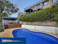  65 Denny St Latham ACT 2615 $800,000 Entertainers Delight Space. Light. Flexibly. Quality. Value. There are so many terms to describe this home. From high ceilings, expansive open plan living and entertainment areas to the northern rural outlook, this home has it all. Fully remodelled to a very high standard, the kitchen and bathrooms are a dream. A spacious light filled family, meals, kitchen area flows through French doors onto extensive timber decking. Segregated bedrooms, a huge laundry, music room, extra large rumpus or a studio with surround sound, extensive under house storage including a cellar and direct access to 4 car garaging. Displaying stunning panoramic bushland views over Umbagong Reserve and Ginninderra Creek from the living areas and decking. A sparkling, solar heated, in ground pool is overlooked by an all weather covered cabana area, ideal for alfresco dining. It is an entertainer's dream. Ideal for the growing or extended family.  Whether it is the birdlife, the breath taking sunsets overlooking the Brindabella, the light, space and other amenities, or simply a great place to live, in the owners words "It is a neighbourhood full of beautiful people and a tightly held secret. It is like living in the country with all the city's conveniences." Enjoy:  - Awesome views.  - 4 bedrooms with 1 study/office.  - 2 bathrooms that are fully renovated.  - Spa Bath.  - Wall to ceiling tiles.  - North facing.  - 3 large entertaining decks.  - Music room.  - Wiring for surround sound movie system.  - Huge Rumpus that can fit a billiard table.  - Wine Cellar.  - Storeroom / workshop.  - Huge family room including meals area.  - Recessed lighting.  - 4 car enclosed car accommodation with automatic roller door.  - Keyless remote entry.  - Reverse cycle air conditioning.  - Gigantic laundry.  - In ground salt water solar heated pool.  - Hardwood polished floors to living areas.  - Spacious modern kitchen with granite benchtops.  - Fish pond.  - Digital antenna.  - Foxtel Cabling. Do yourself a favour and come and look at this majestic home and compare the value and all the bonuses that you are getting compared to the new suburbs. This home is close to shops, public transport and schools yet it has a setting which is quiet and tranquil and that gives you a sense of peacefulness. For more information please call Greg Sadil on 0414 631 607 Energy Efficiency Rating: 2.0-star NABERS Energy Rating For Sale Offers Over $800,000 Features General Features Property Type: House Bedrooms: 5 Bathrooms: 2 Indoor Study Floorboards Built in Wardrobes Rumpus Room Reverse cycle Air Conditioning Outdoor Remote Garage Secure Parking Garage Spaces: 4 Deck Outdoor Entertaining Area Fully Fenced Swimming Pool - Inground Eco-friendly Inspections Inspections by appointment only. 
