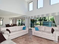  2 Monte Carlo Heights Port Kennedy WA 6172 $895,000 Two Homes in One..! Located in a sheltered spot in the Ocean Edge estate approx. 250m from award winning Warnbro Beach, this superb home has a massive 420sqm of living area extending over 3 levels on a generous 707sqm block. It is like 2 homes in 1. The main living area has a huge open plan family & dining area which is adjacent to a large chef's kitchen & breakfast bar. There are 3 spacious bedrooms the main with custom robes - 2 ensuite bathrooms and a ground floor powder room. An attached guest quarters/granny flat has a huge bedroom, ensuite bathroom, lounge/living room and kitchenette, and can be accessed either internally or externally from the main house, so privacy is assured. A feeling of spaciousness is enhanced by a void over the family area, and high ceilings throughout the ground floor. The main living areas overlook a stunning b/g pool wrapped around a gazebo, nestled in a beautiful landscaped garden. Unwind to the sound of water splashing down the pool's waterwall and rising from the bubblers close to the gazebo's bridge. Or go to the movies in the fully equipped home theatre room. There is also a large ground floor home office just off the front entry, a huge, 30 sqm loft accessed by the 2nd staircase, and a large storage space/wine cooler under the main staircase. A "Webb & Brown Neaves" house, it is well built and has quality fittings throughout. It is cooled & heated by 2 separate reverse-cycle, ducted A/C units with another reverse-cycle A/C unit in the loft. Curtains and pelmets frame the windows in all living areas and bedrooms, and floors have lovely woollen carpet or porcelain tiles. There is a fully monitored security system, smart-wiring and an integrated entertainment system that plays music throughout the main house & outside entertainment area as you chose. Secure parking is provided by the 2 and a half car-sized garage. Storage space abounds throughout the house and garage. 